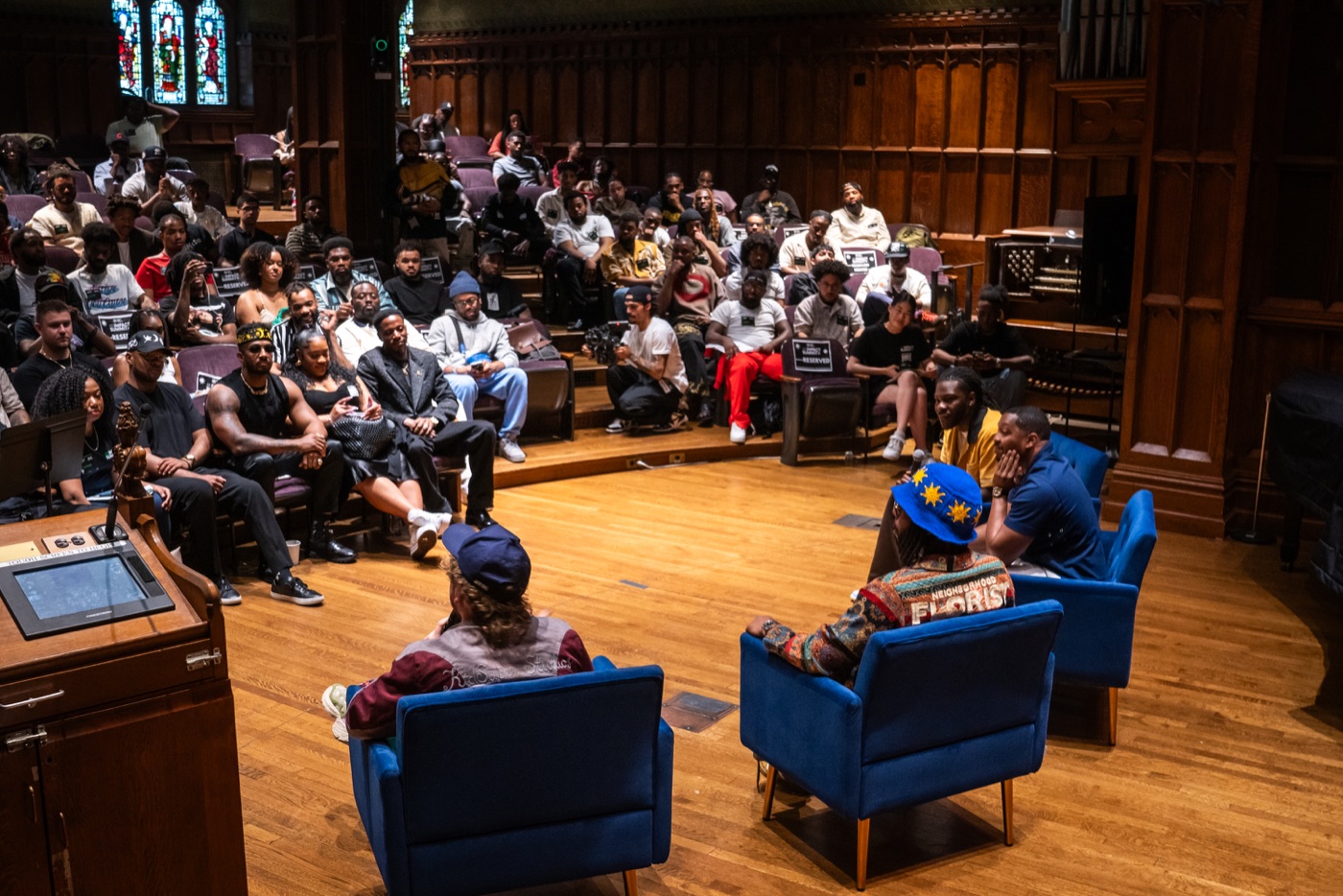A full auditorium participating in a live Project High-Lvl learning session
