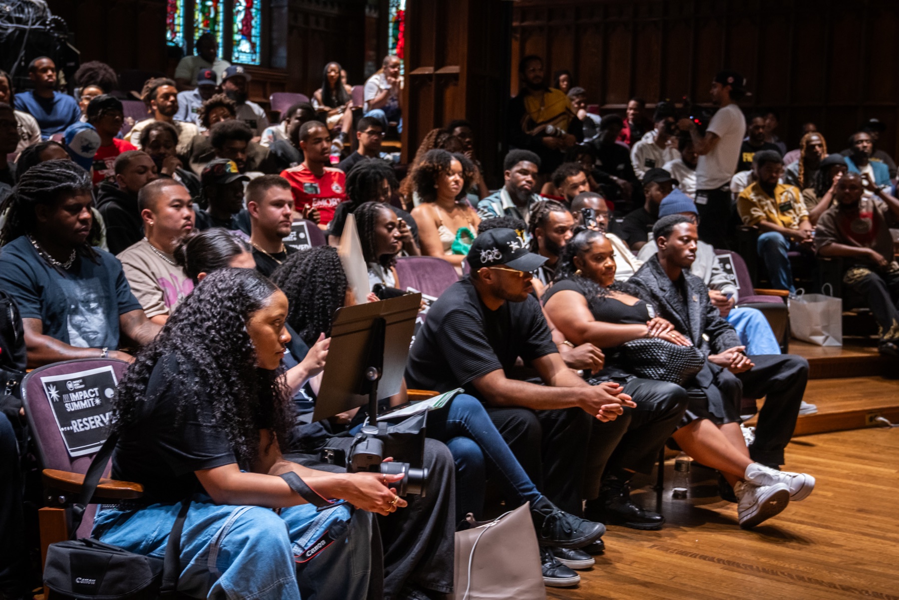 Students and community members filling an auditorium during a Project High-Lvl event